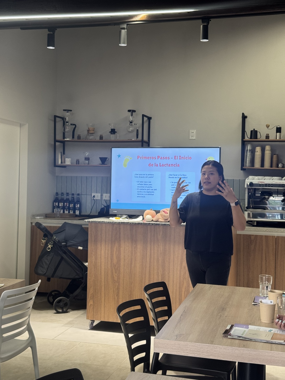 Melody speaking in front of a breastfeeding education slide.